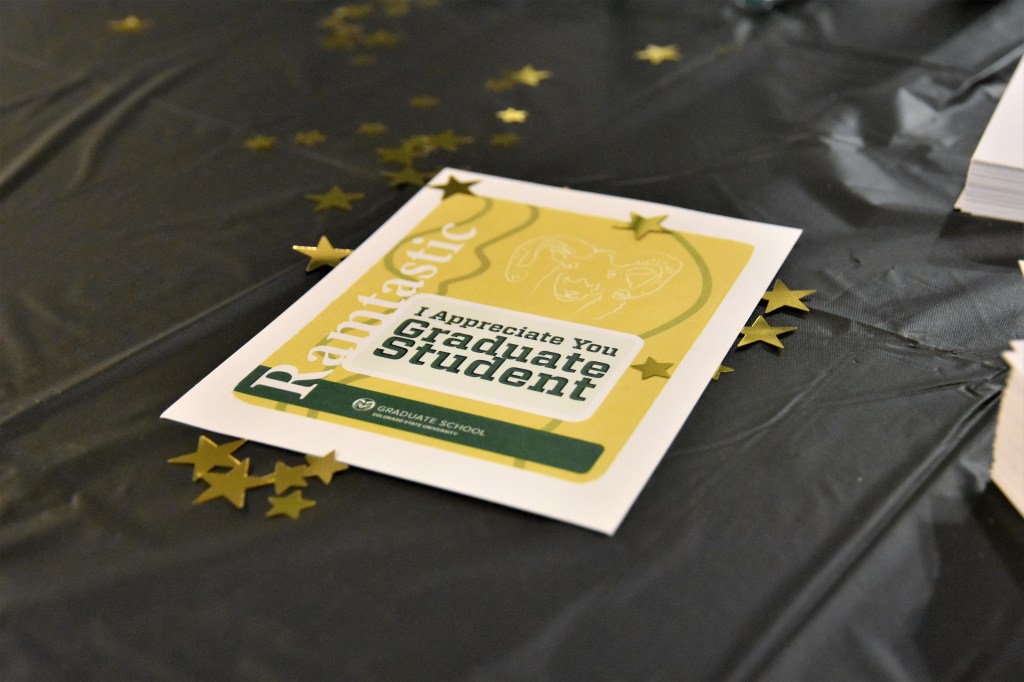 Graduate Student Appreciation card on black tablecloth with gold stars