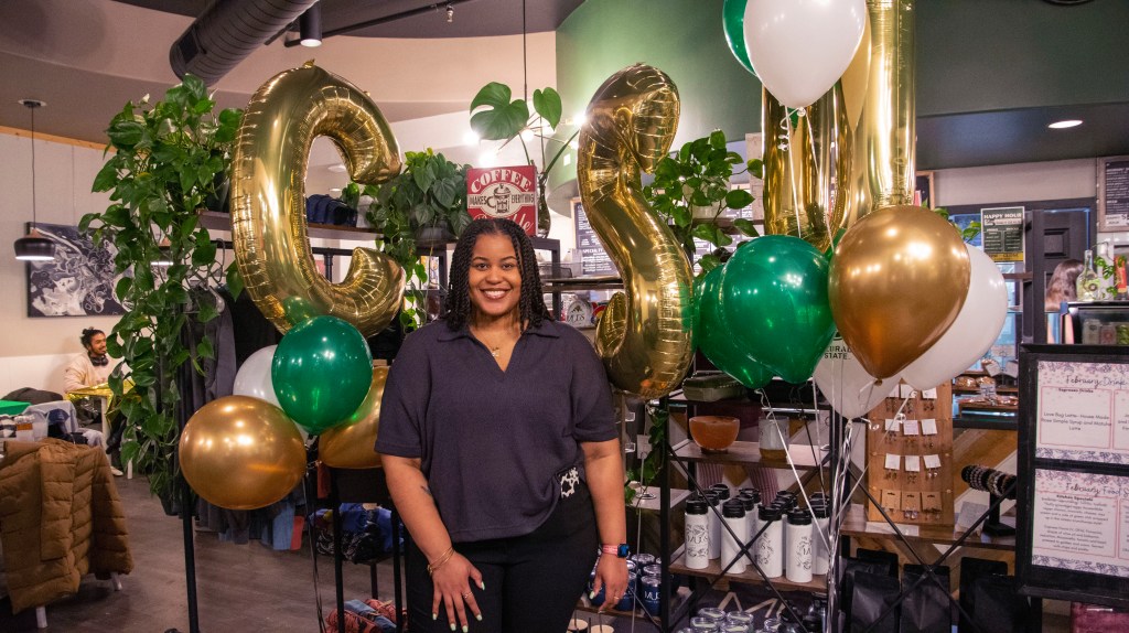Graduate Student in front of CSU decorative balloons